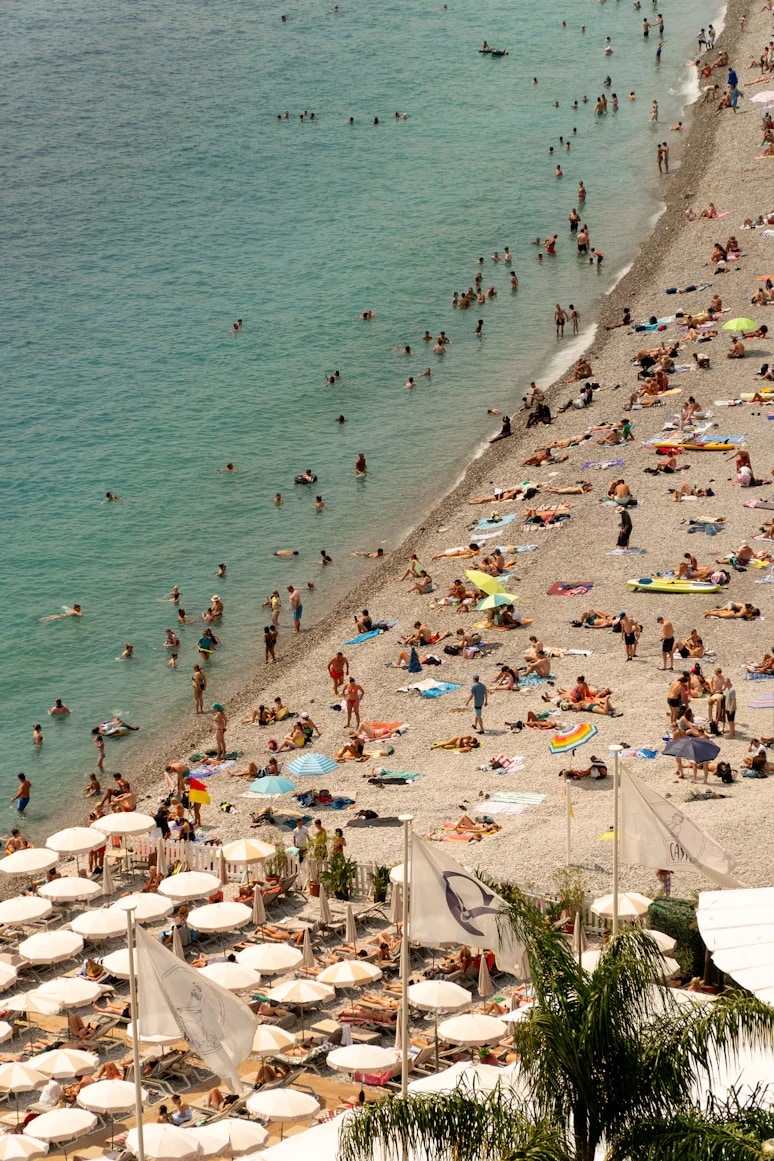 A busy beach with turquoise water